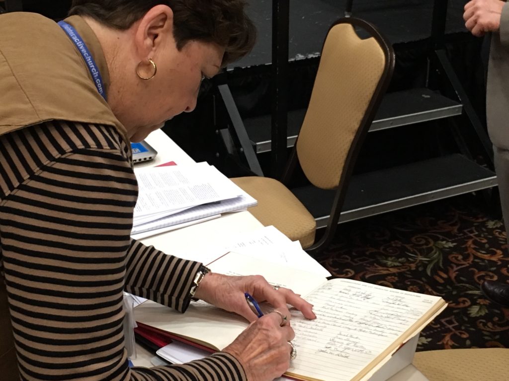 Ruth Waeltz siging the Constitution of the Synod 2018